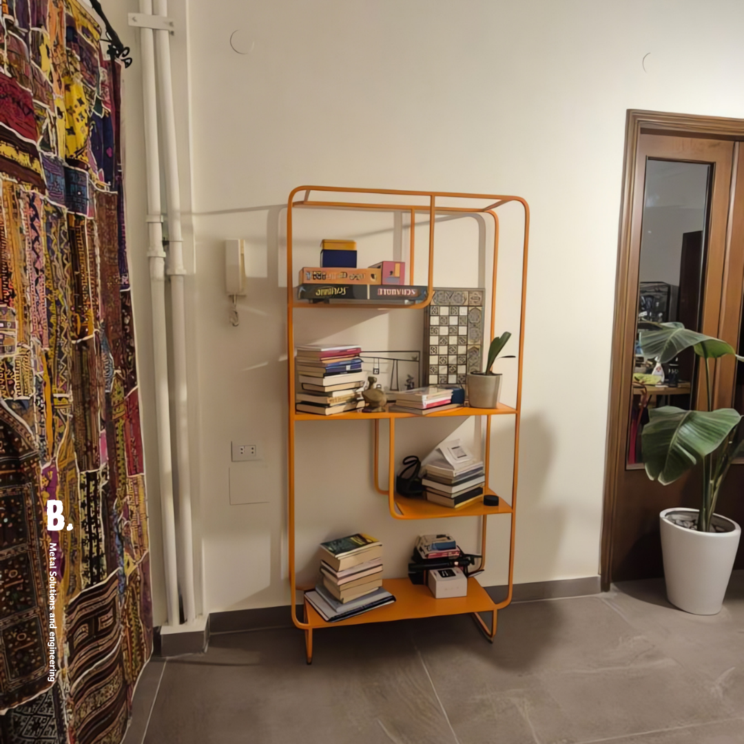 Orange metal Alana bookshelf from Urban Outfitters, displaying books, vases, and a speaker. Modern open shelving unit for home decor and storage in Lebanon.