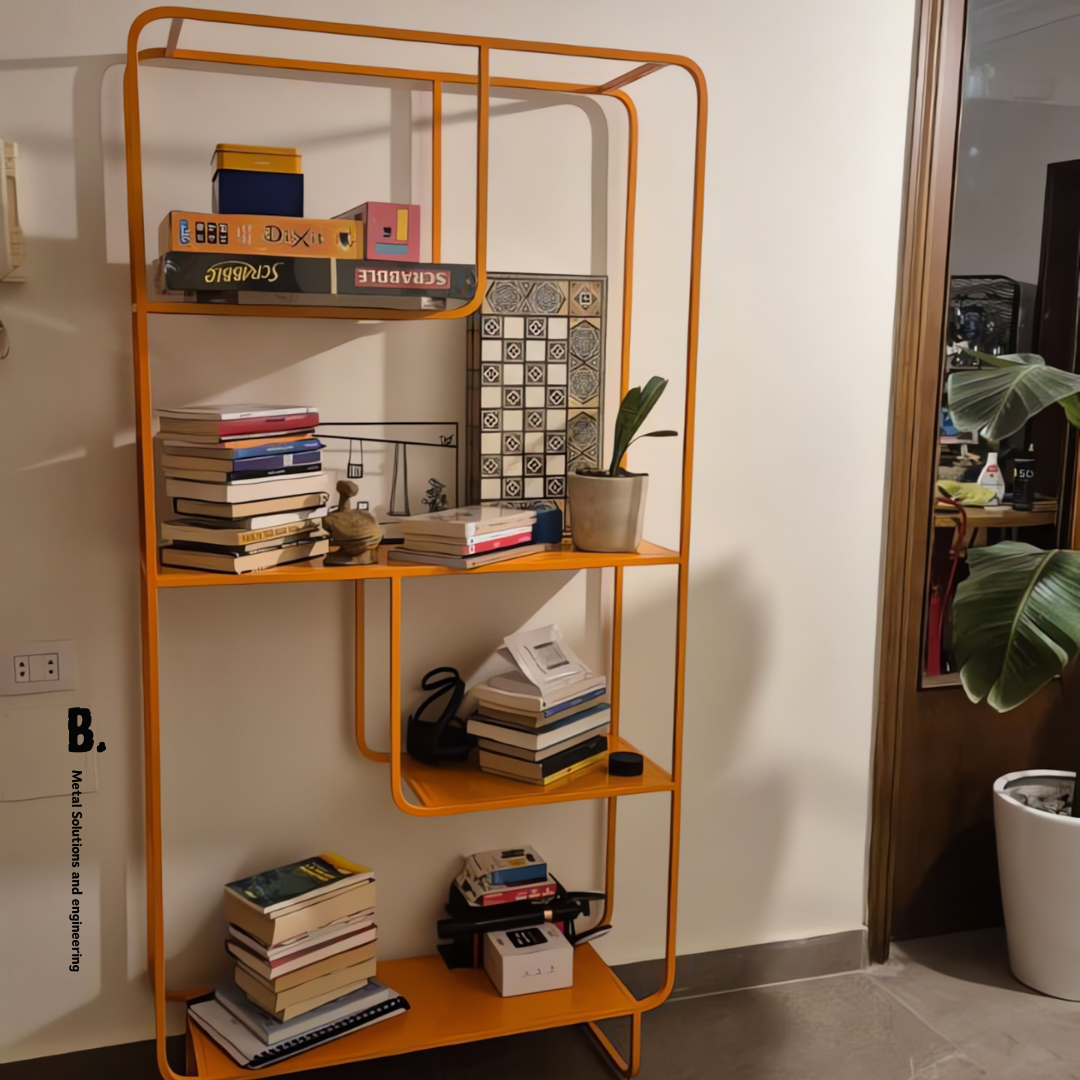Orange metal Alana bookshelf from Urban Outfitters, displaying books, vases, and a speaker. Modern open shelving unit for home decor and storage in Lebanon.