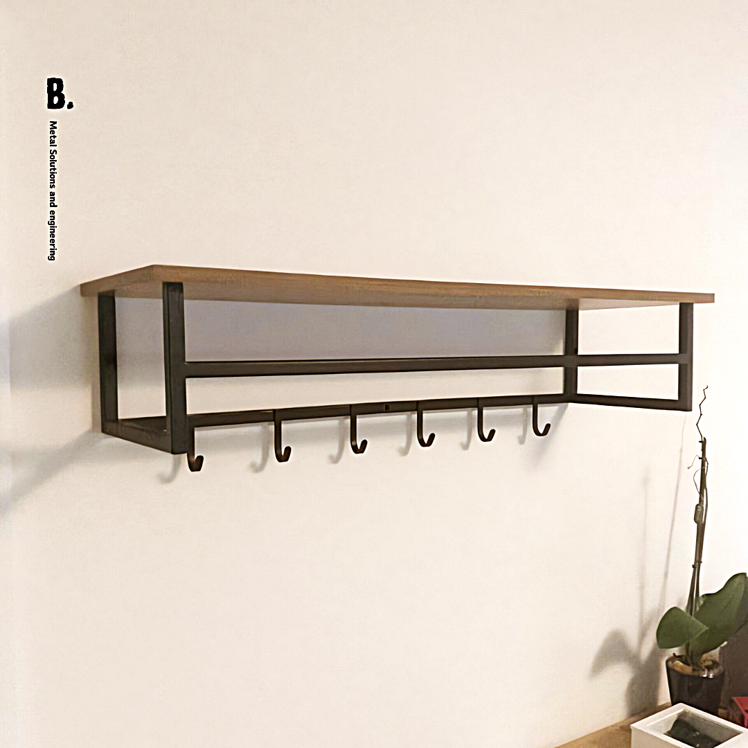 Wall-mounted coat rack featuring a thick, light-colored wooden shelf with a natural edge, resting on a minimalist black metal frame with a hanging rod and six triangular hooks