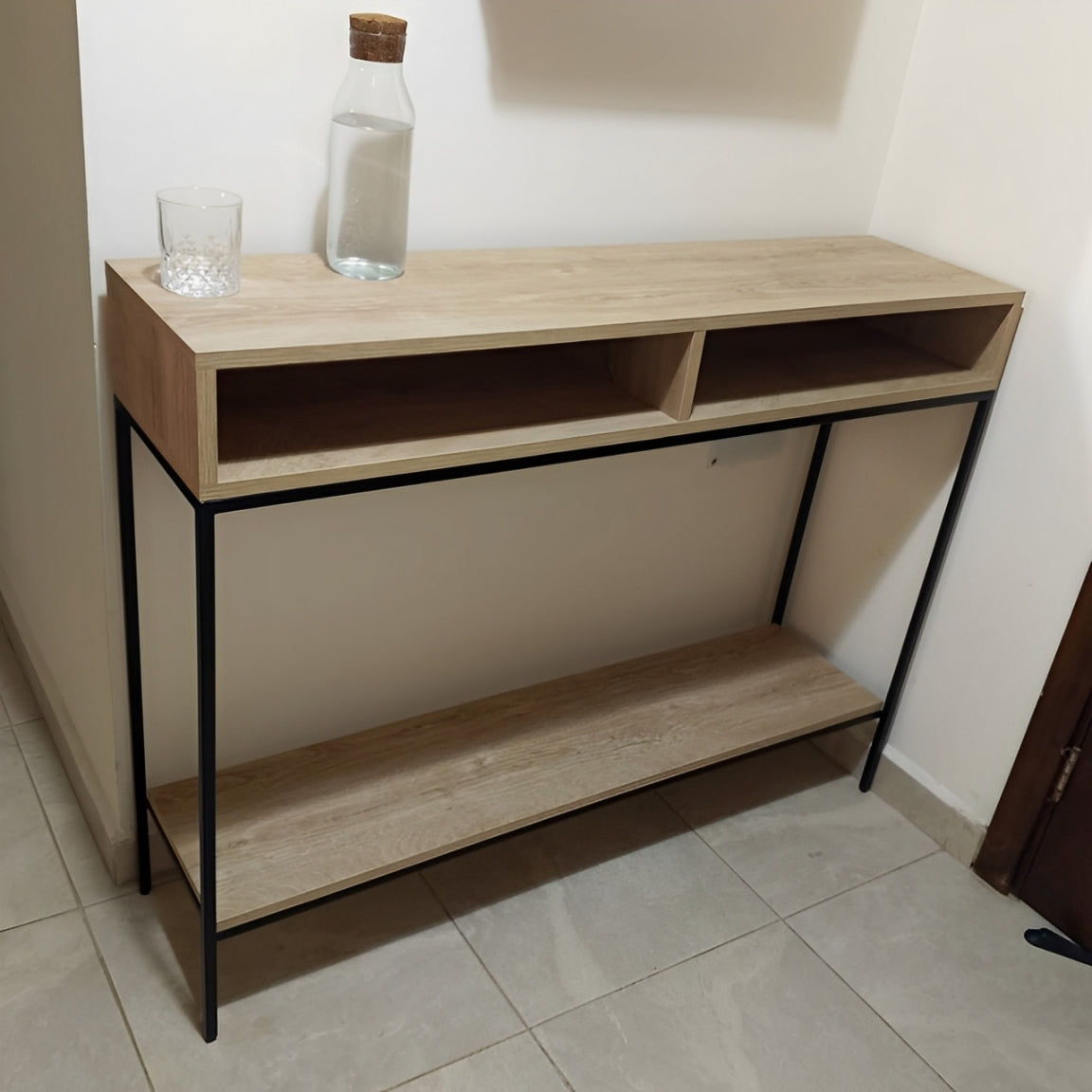 Modern console table with a light wood finish, black metal frame, lower shelf, and two top compartments.