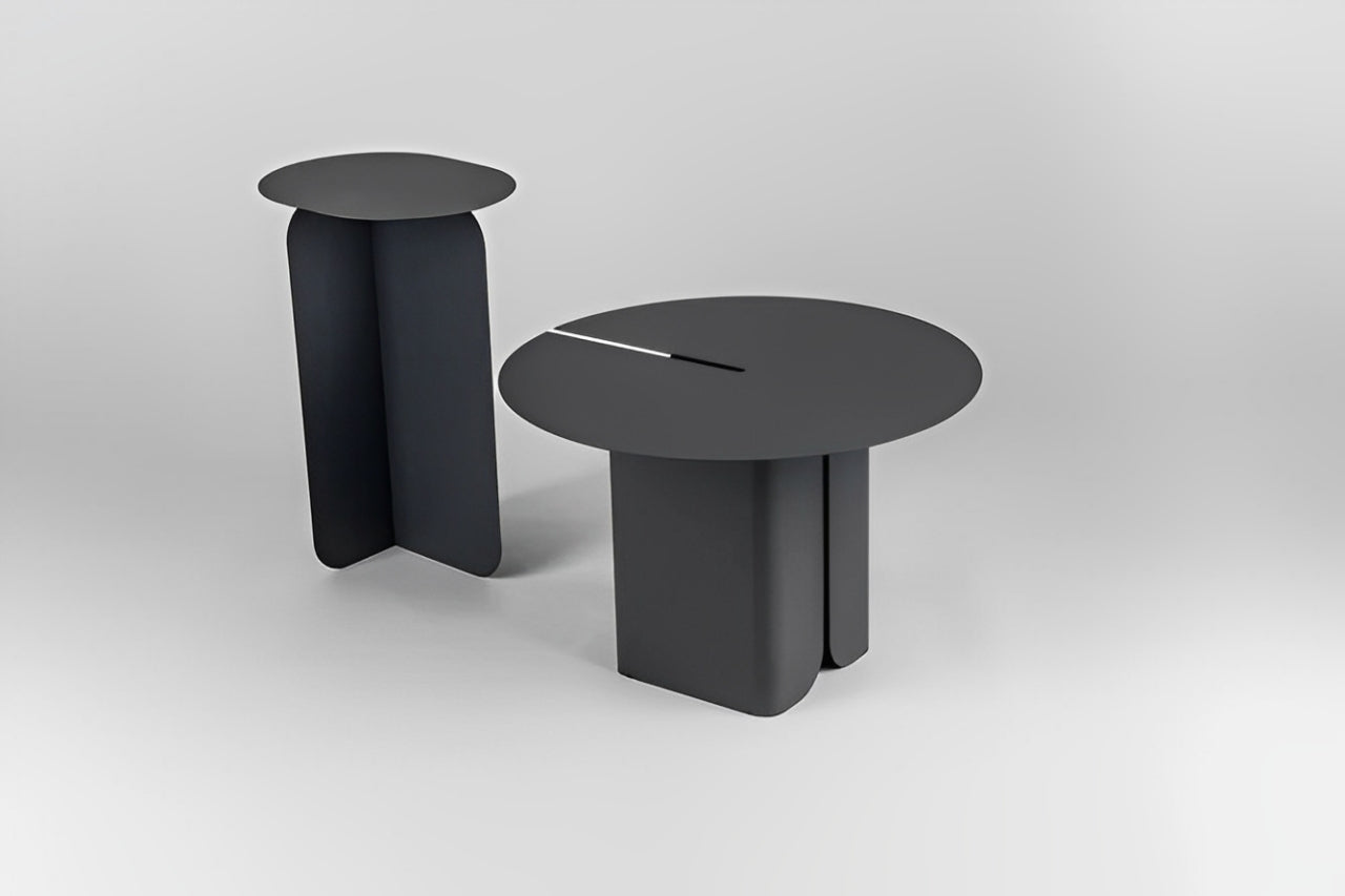 Modern gray round side table with tiered design, gold geometric sculpture, and book.