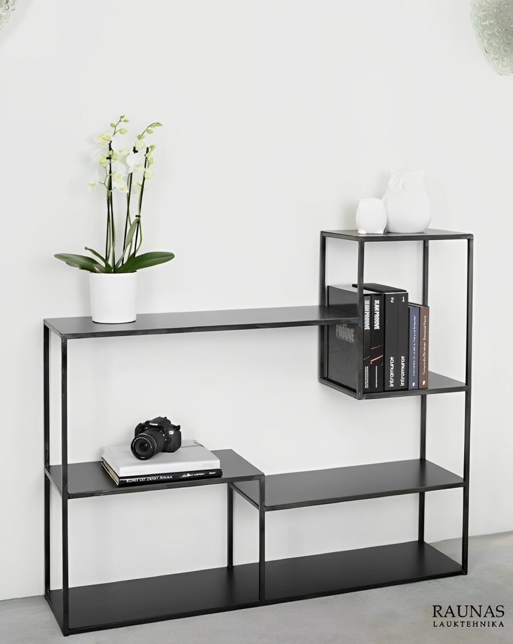 Modern black shelving unit with an open and airy design, perfect for displaying books and decor.
