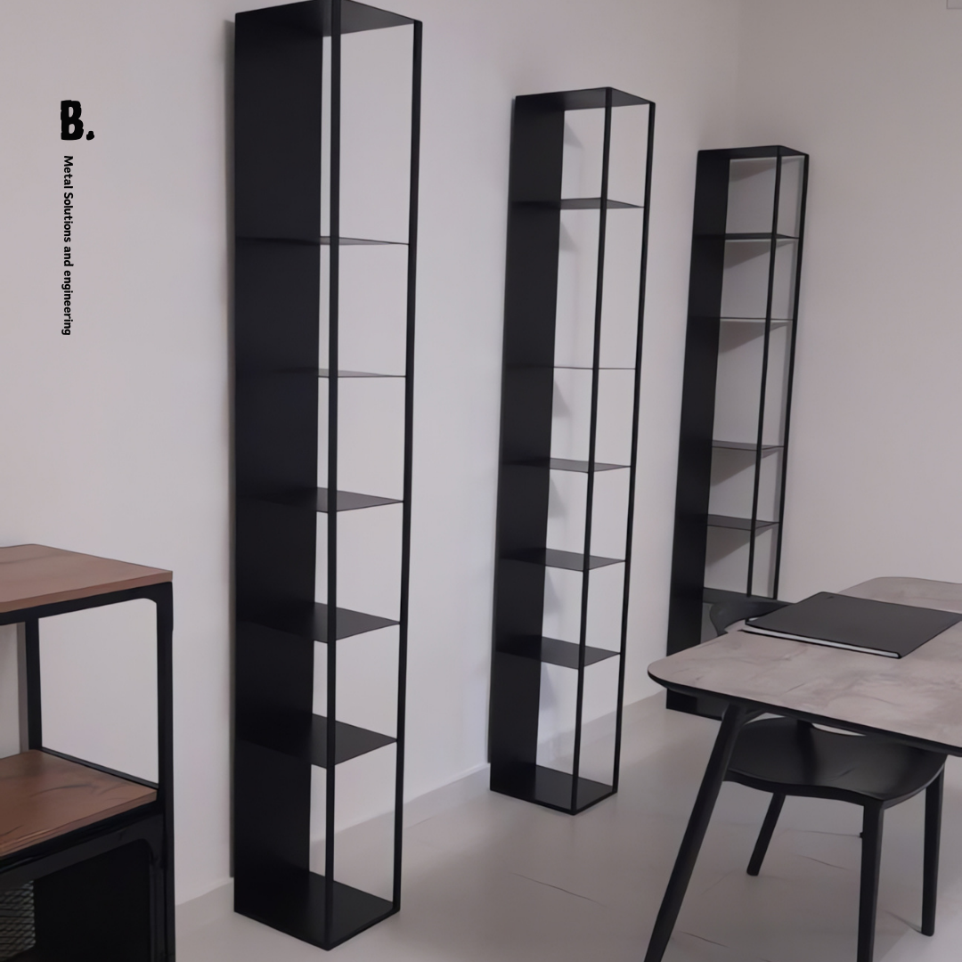 Contemporary black metal modular bookcase, open shelving design. Styled with books and vases. Ideal for modern Lebanese homes, with a framed abstract artwork.
