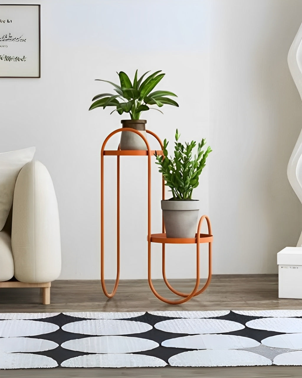 Modern black metal plant shelf with a thin, curved frame. The shelf has two tiers: a small round shelf on the right and a taller rectangular shelf on the left.