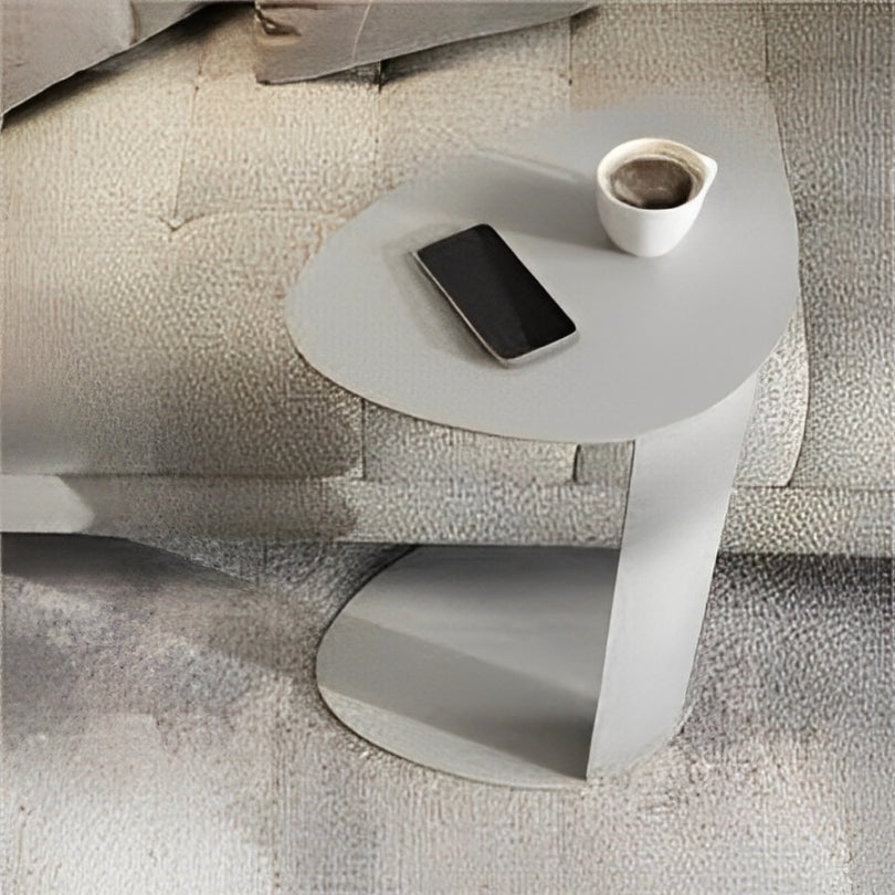 White side table with a slim, space-saving design and unique top shape.