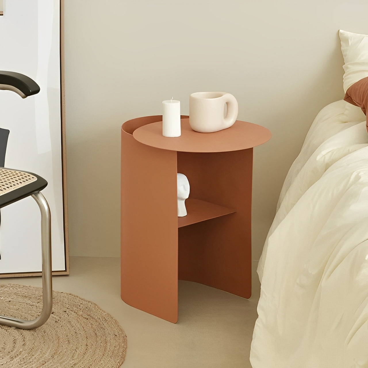 Modern minimalist bedside table in a warm orange hue, with a cylindrical design and a built-in shelf.