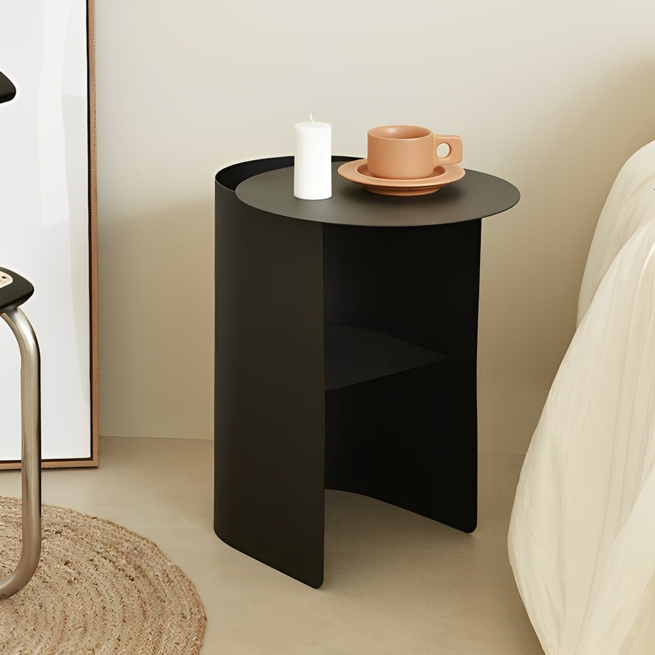 Modern minimalist bedside table in a black hue, with a cylindrical design and a built-in shelf.