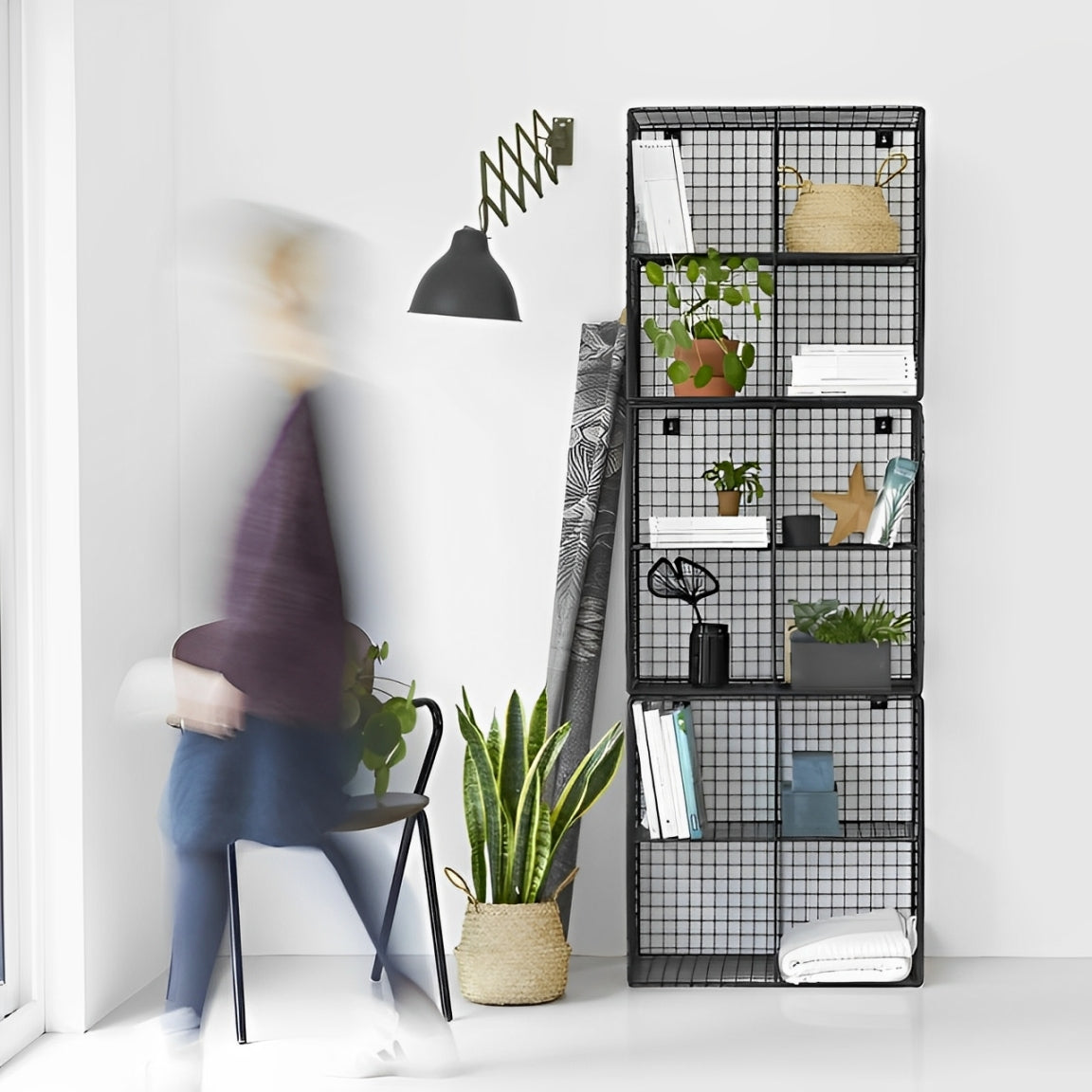 trio mesh bookshelf 3-module metal bookcase, black wire mesh, industrial-modern design. Displaying plants, books, and decorative items. Ideal for contemporary Lebanese homes
