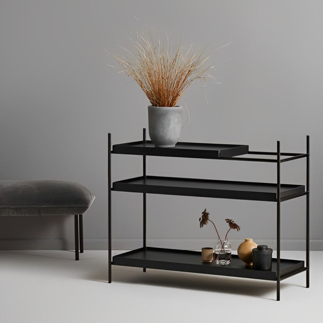 Wood Tray Shelf Low in black, featuring three lipped tray-style shelves displaying vases and a pot with dried grass.