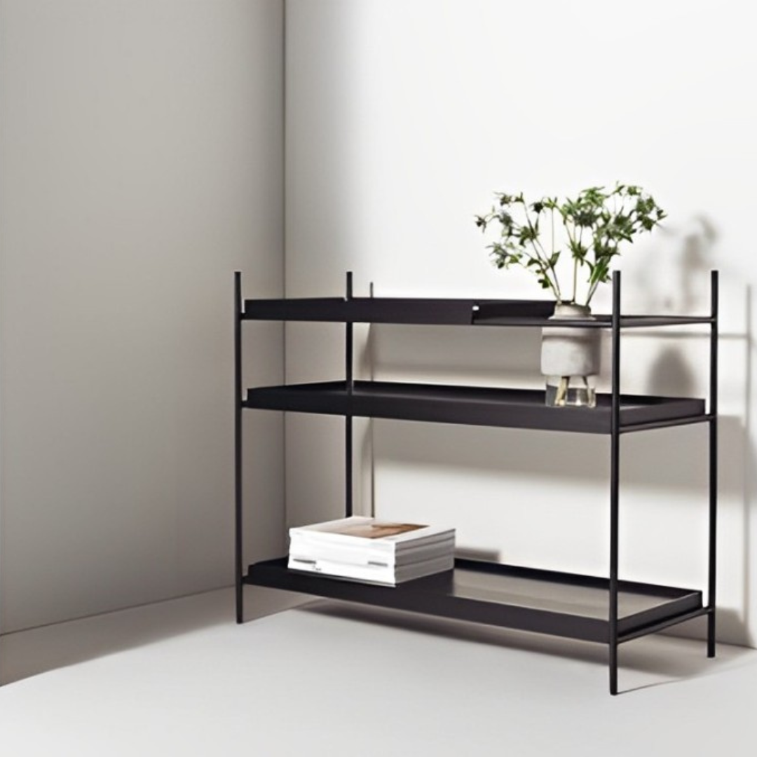 Wood Tray Shelf Low in black, featuring three lipped tray-style shelves displaying vases and a pot with dried grass.