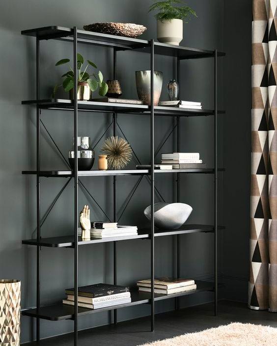 Emery Black Metal 4-Shelf Bookcase displaying books, vases, plants, and decorative objects. Modern industrial shelving unit for home decor and storage in Lebanon.
