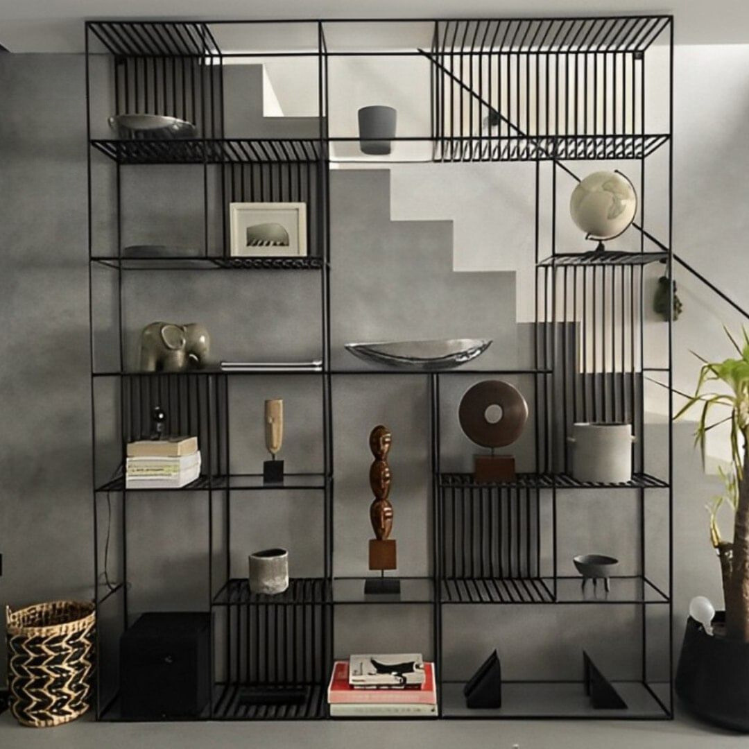 Grid Black Metal Modular Shelving Unit with multiple compartments, displaying books, vases, and decorative objects. Modern industrial shelving for home decor and storage in Lebanon.