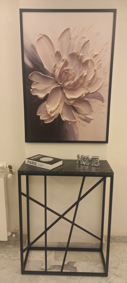 Black metal console table with a dark top and abstract leg design