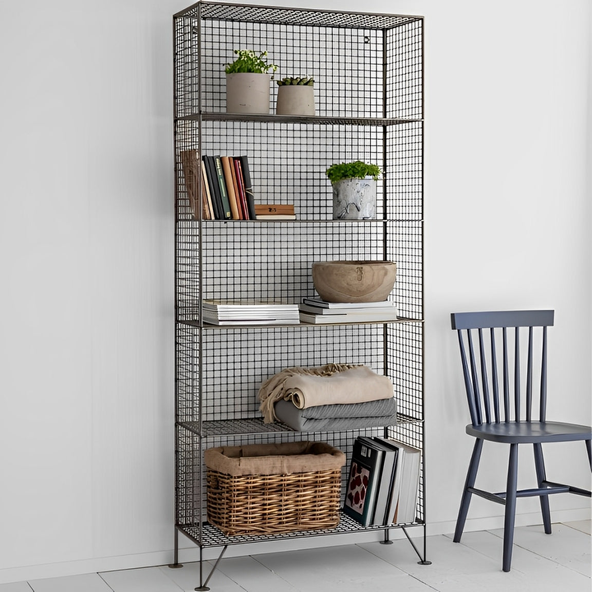 Black metal mesh shelving unit, Decorative metal shelving unit for plants and books.

