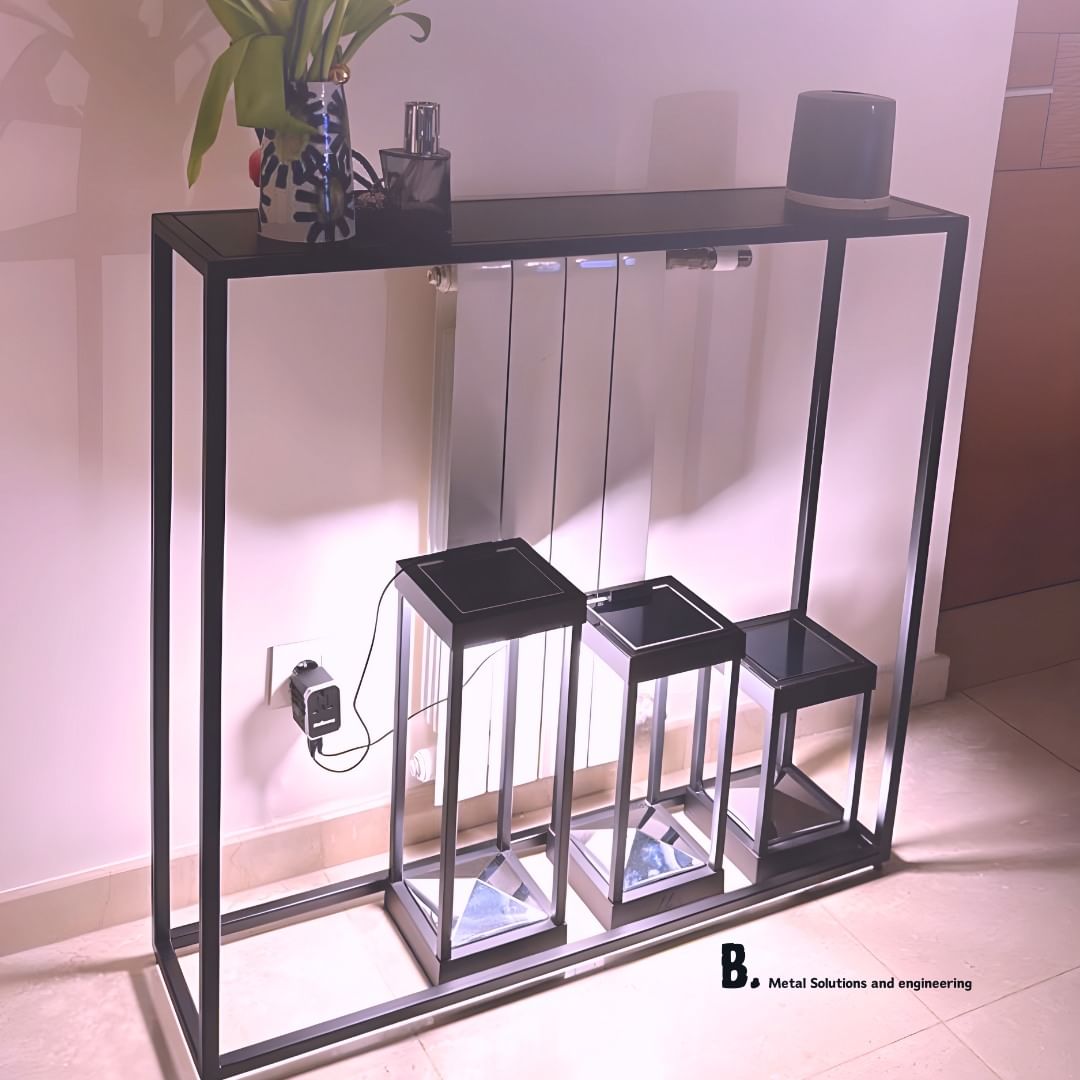 Modern black console table with nested side tables and decorative items