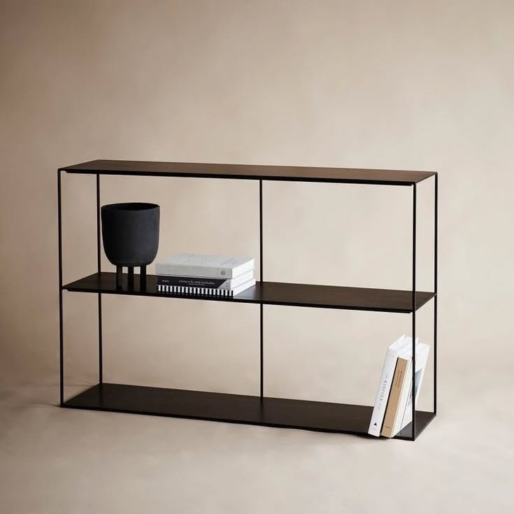 Slim Irony black two-shelf sideboard with a minimalist open frame design, displaying a vase and books.